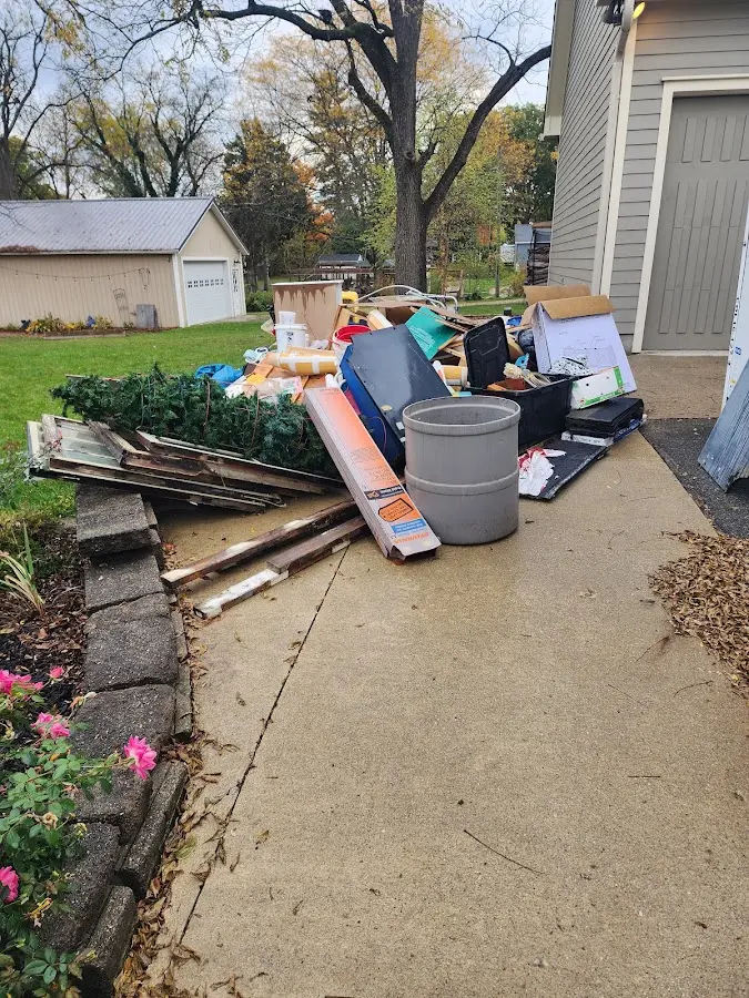 Dumpster being loaded with debris for 10 Yard Dumpster Rental in Sawmills